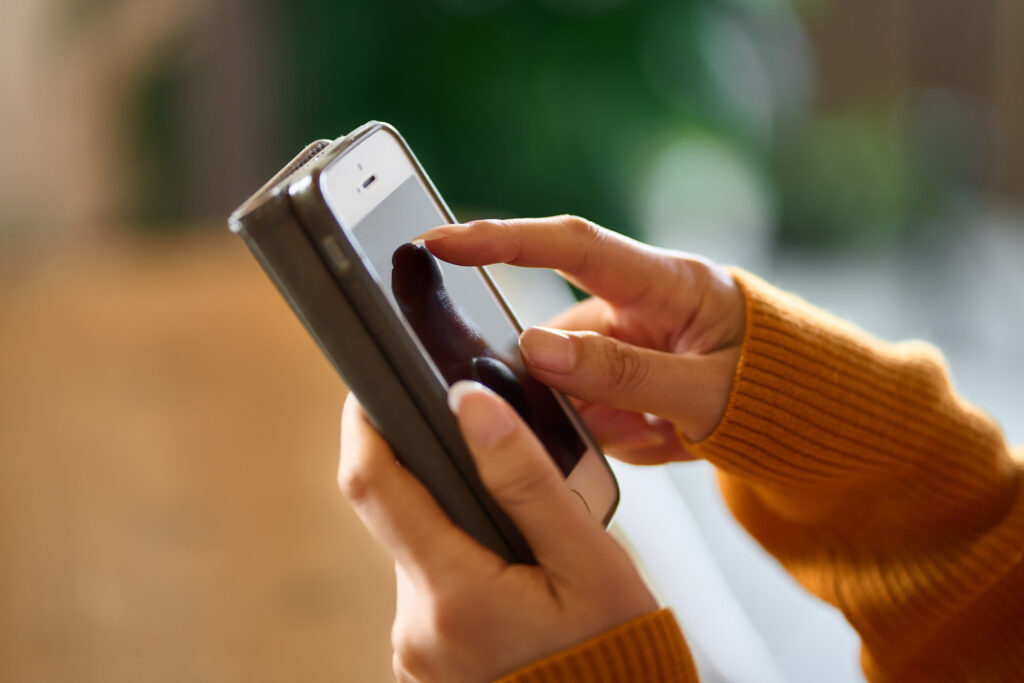 Two female hands holding a smartphone